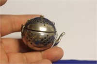 A Sterling Teapot Form Tea Strainer