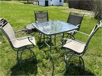 Patio table and four chairs. Chairs swivel.