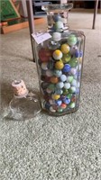 Glass bottle of marbles with lid
