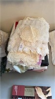 Stack of doilies , table coverings, towels, etc.