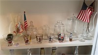 Shelf lot of shot glasses and miscellaneous glass