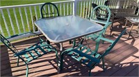 4 metal chairs and glass top patio table