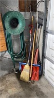 Broom snow shovels, rake, hose, hose holder