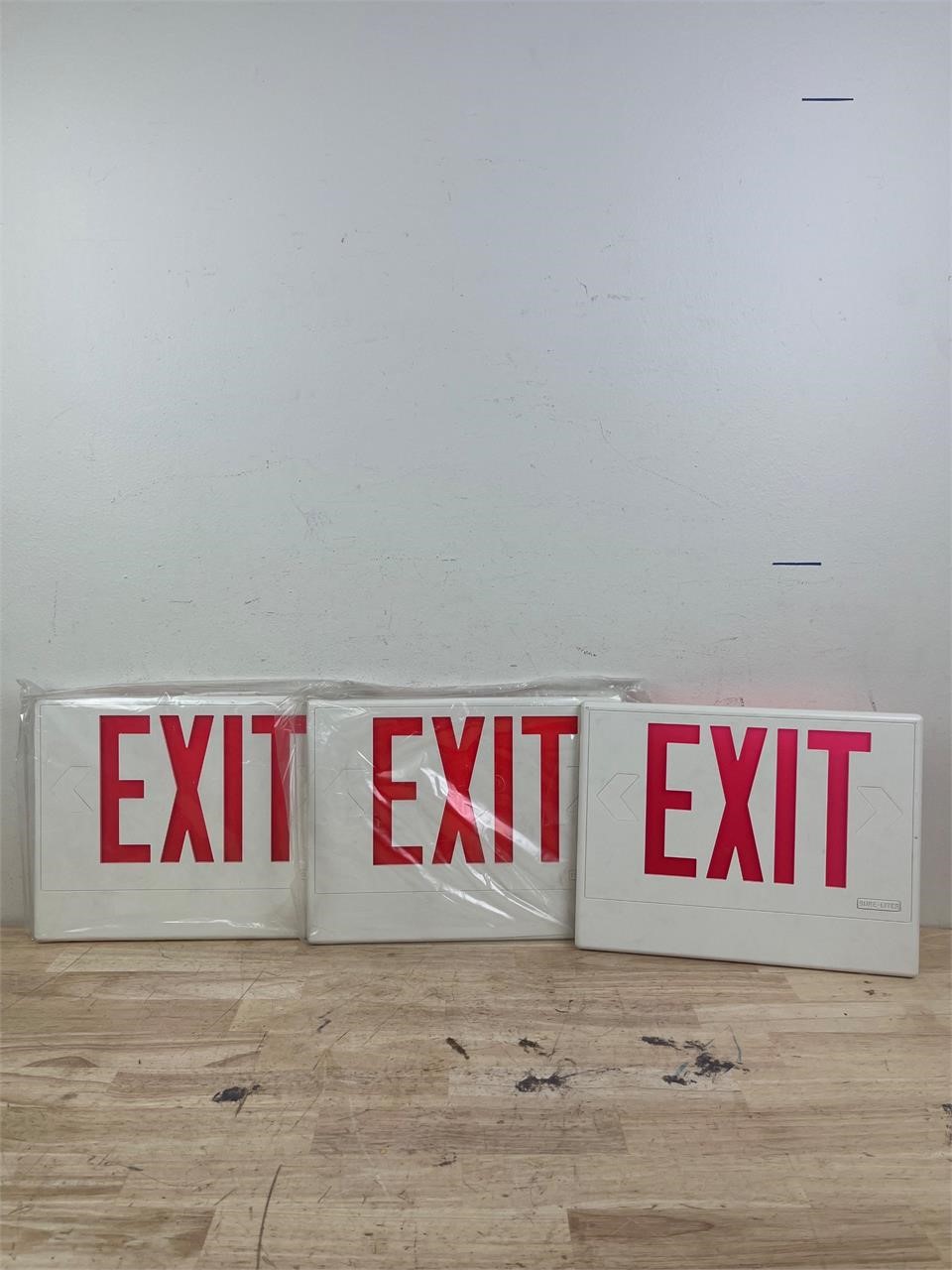 Three EXIT signs