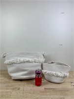 Two white decorative baskets