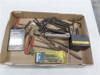 assortment of drill bits, allen wrenches, punches