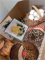 Basket filled with ceramic eggs, trivets, paper