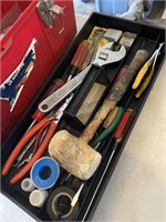 Red plastic toolbox filled with a variety of