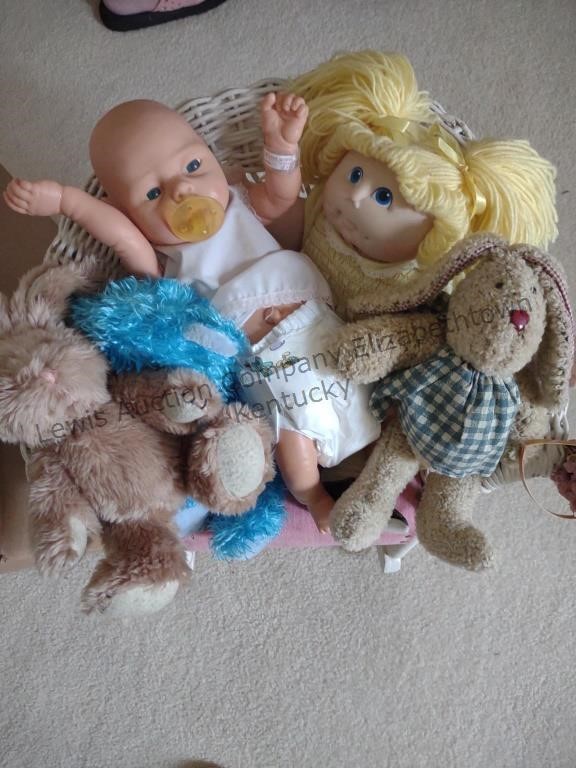 Box of dolls and a child's wicker rocker