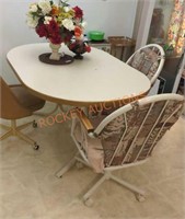 Kitchen table with three rolling chairs