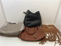 Assorted fashion handbags and purses.