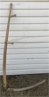 Vintage scythe with wooden handle and metal