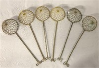 SIX SMALL GOLD STRAINER BASKETS