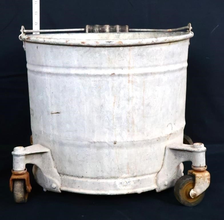 Vintage zinc mop bucket on wheels