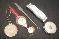 Hohner harmonica, small ball clock, tape