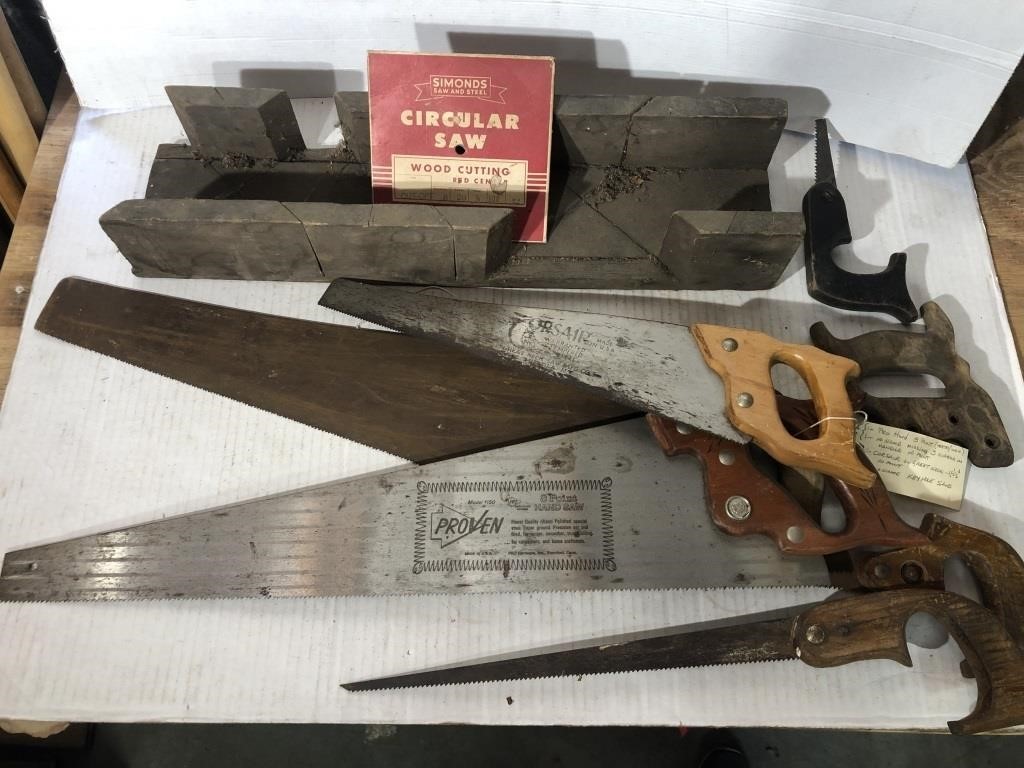 Vintage cross cut saws and wooden mitre box