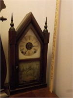 C. brown tin face steeple clock