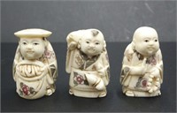 Three Japanese carved bone young men netsukes