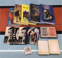 Hardcover novels, post cards, playing cards