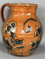 Folk art slipware decorated redware pitcher by