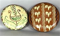2 folk art redware slip decorated chargers by