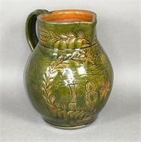 Folk art green sgraffito worked redware pitcher