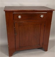 One door cabinet ca. 1820; in pine with a dark