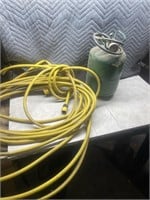 Empty Freon tank and a garden hose