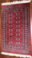 A SIGNED AND HAND KNOTTED RUG IN TURKOMAN BOUKARA