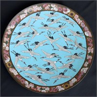 AN ANTIQUE CLOISONNE CHARGER WITH CRANES IN FLIGHT