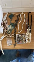 Beaded necklaces, pin assortments, and earrings