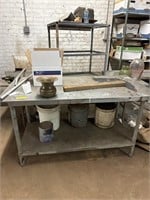 Two metal working tables contents on an under