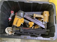 Black and yellow tote of pneumatic nailers