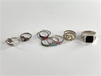 About 9 sterling silver rings, various sizes