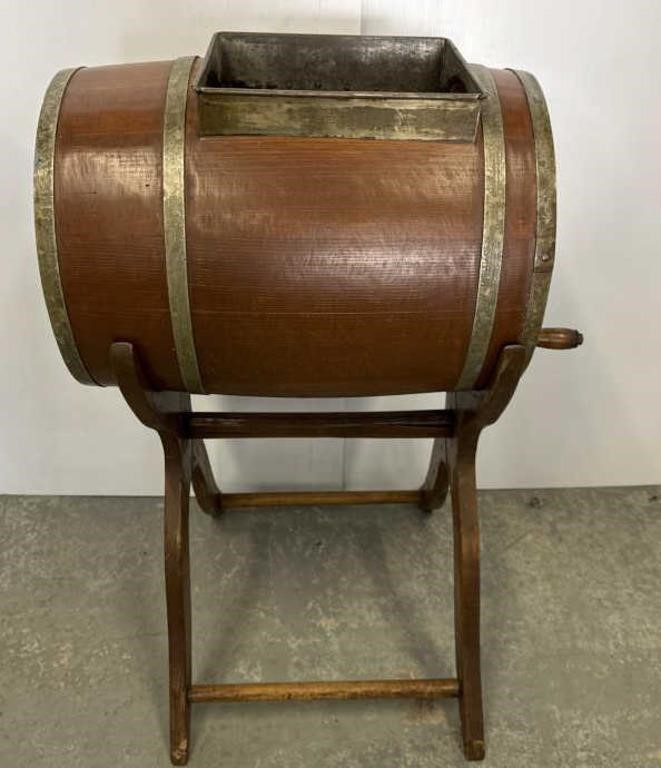 Wooden churn barrel on stand