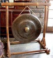 A MASSIVE HAMMERED BRASS GONG SUSPENDED ON BAMBOO