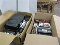 VHS player and two boxes of vintage VHS movies