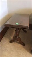 Wood side table with glass piece on top.