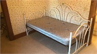 Daybed with white metal frame & mattress.