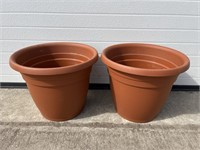 2 orange plastic planters
