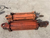 2 orange hydraulic cylinders