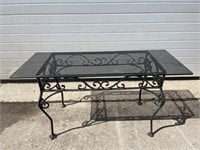 Small metal based glass top patio table