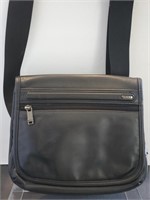 Tumi black leather flap cross body bag