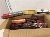 Box of HO train track, engine & box cars