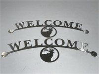Two Metal Welcome Signs