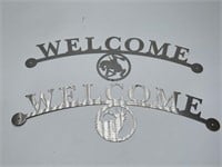 Two Metal Welcome Signs