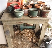 Collection Of Small Pots On Wooden Table
