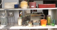 Two Shelves Of Small Pots And Garden Decor