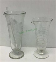 One pair of vintage medicine beakers - one is