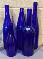 Lot of five bearing size cobalt blue bottles -